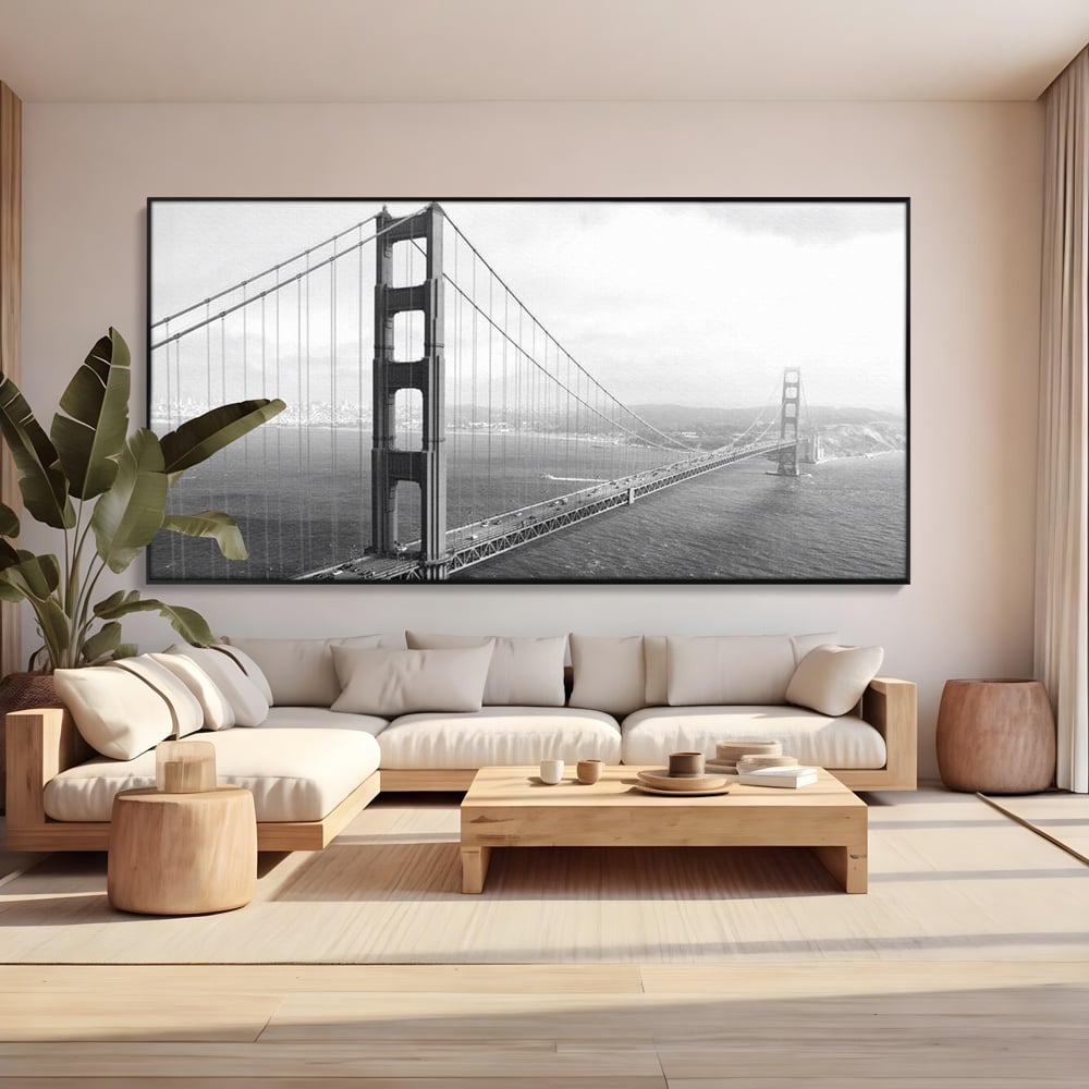 Tablou canvas cu fotografie alb-negru cu podul golden gate, in rama de aluminiu negru, pe perete intr-un living